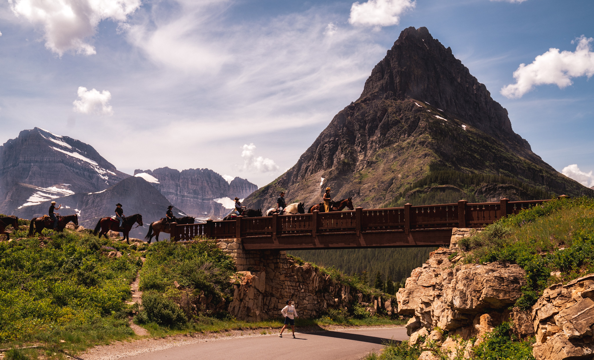 Horseback riders crossing a bridge at Glacier National Park